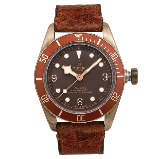 Tudor watch with brown strap and red bezel on a white background